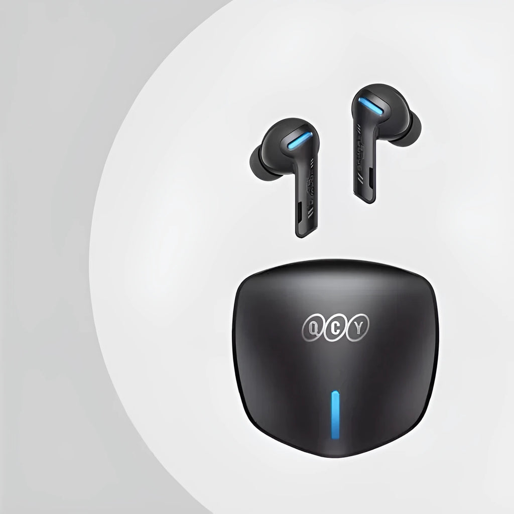Grey QCY-G1 wireless in-ear gaming headset and its portable charging case on a table.