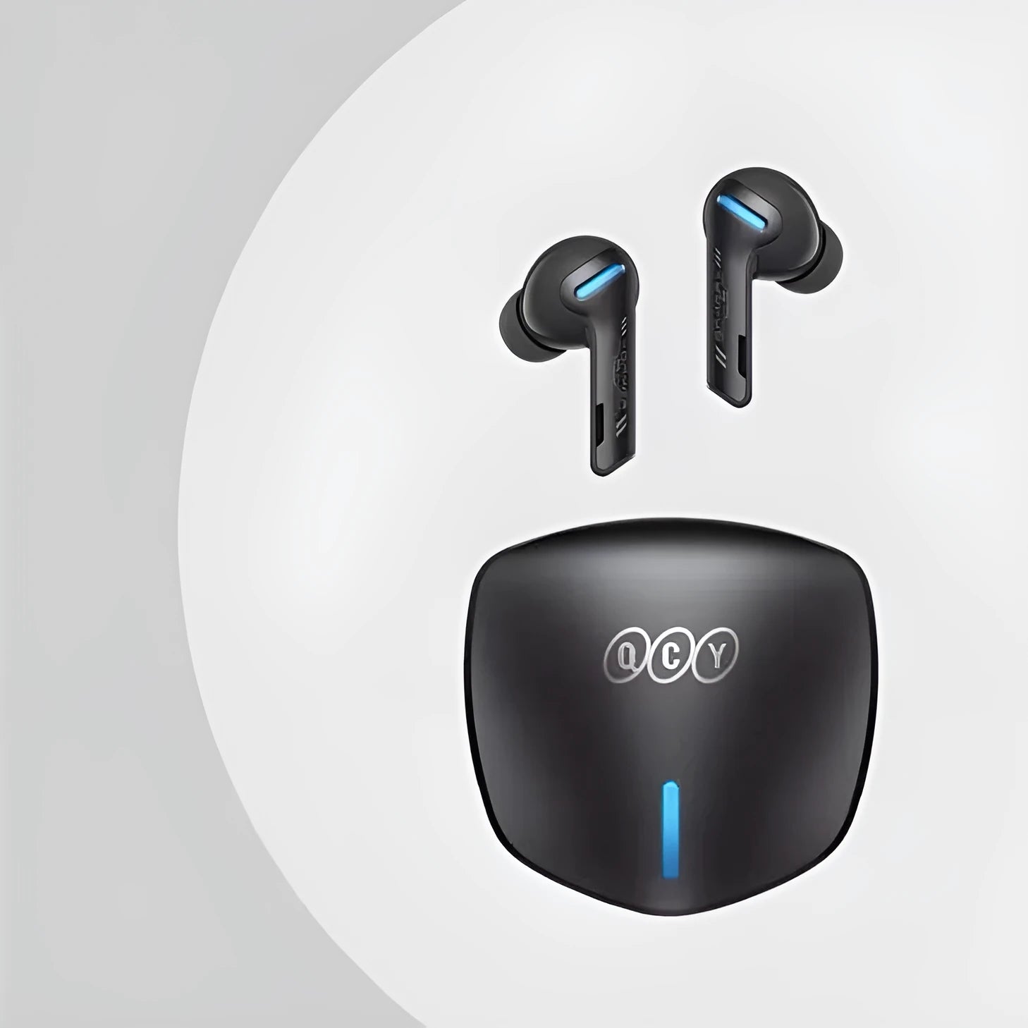 Grey QCY-G1 wireless in-ear gaming headset and its portable charging case on a table.