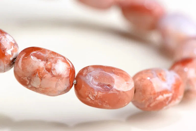Natural cherry agate bracelet with 10x14mm barrel beads and Ruyi geometric elements