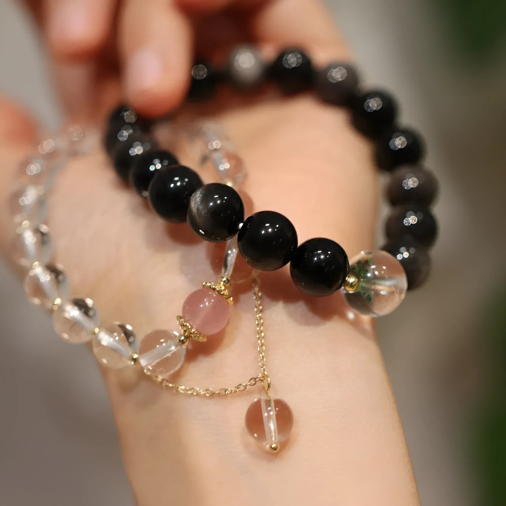 Chinese style geometric crystal bracelet with cat eye obsidian effect and auspicious patterns.