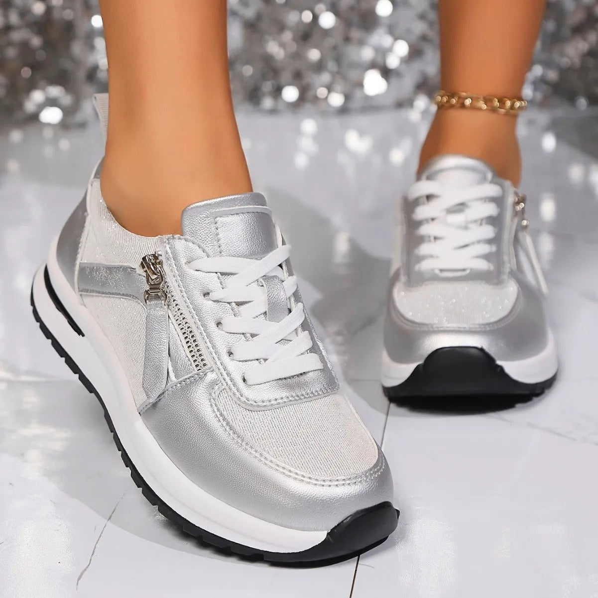 Gold women's lace-up pumps with round toe and flat rubber sole on a white background.
