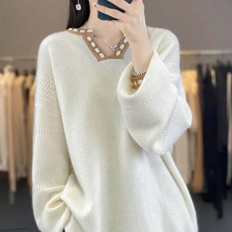 Women's camel-coloured V-neck long sleeve viscose sweater laid flat.