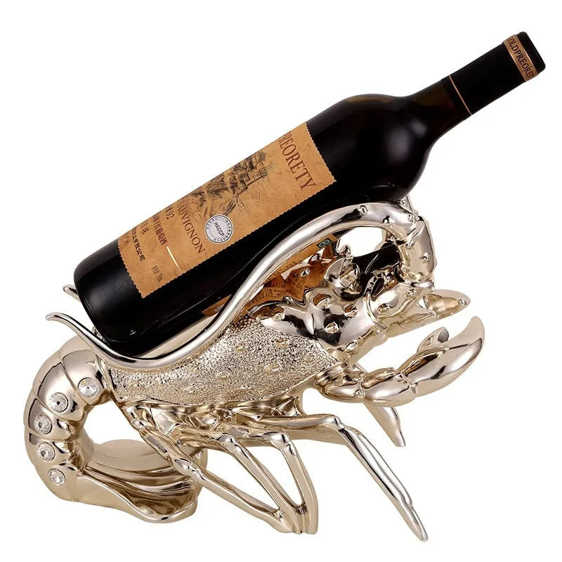 Decorative lobster-shaped wine rack ornament in rose gold or silver resin and plastic on a tabletop.