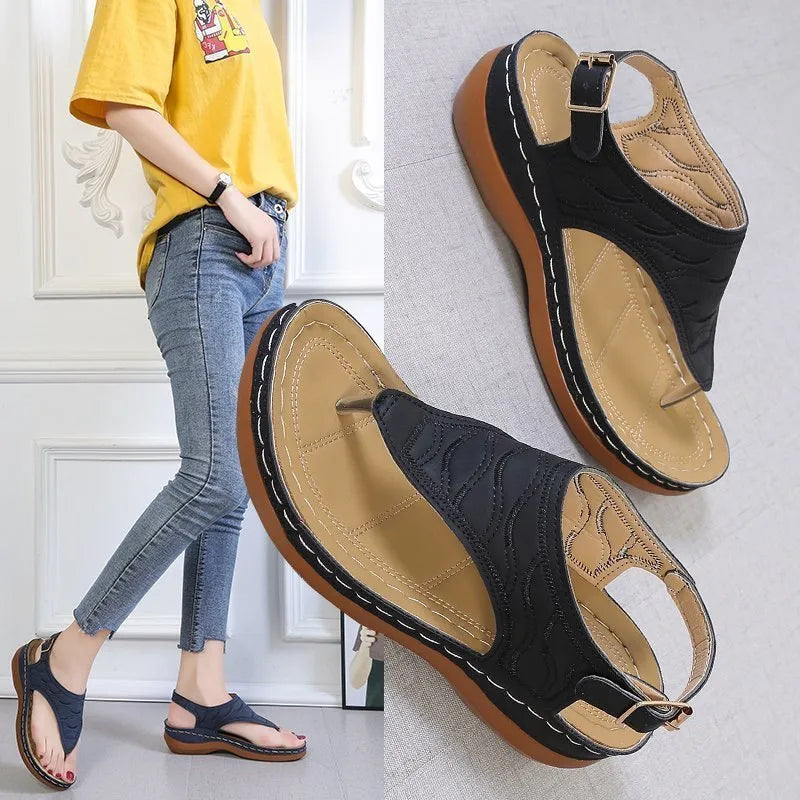 Women's casual wedge heel flip flop sandals with an adjustable buckle strap in a solid colour.