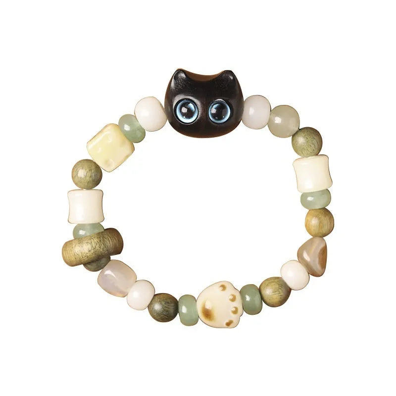 Hand-woven Buddhist bracelet with jade beads, wood elements, and cat's paw charm in rosewood or ebony with yellow or blue eyes