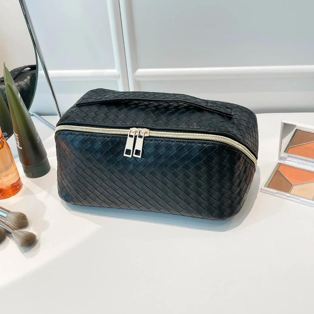 Waterproof large capacity PU storage bag in white, open showing cosmetics inside