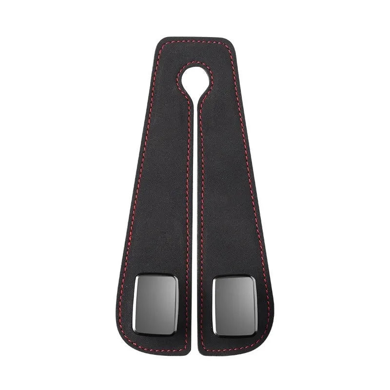 Black suede car seat hook attached to a headrest post, holding a shopping bag.