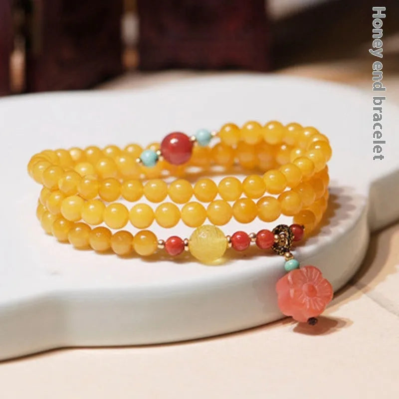 Yellow amber bracelet with 5mm round shape and animal zodiac design in retro style.