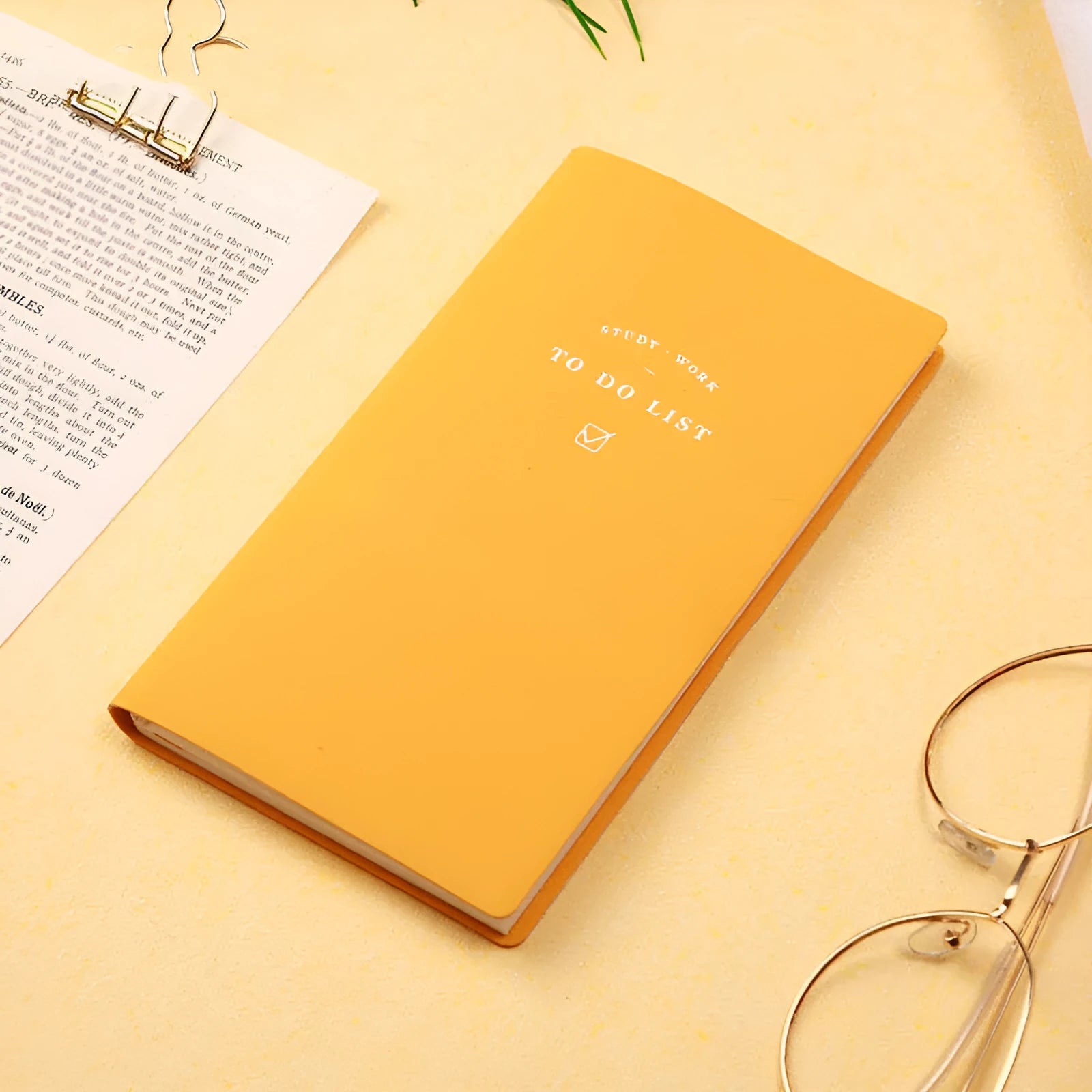 A simple portable todolist notebook in morandi blue with a PU cover, shown next to a pen.