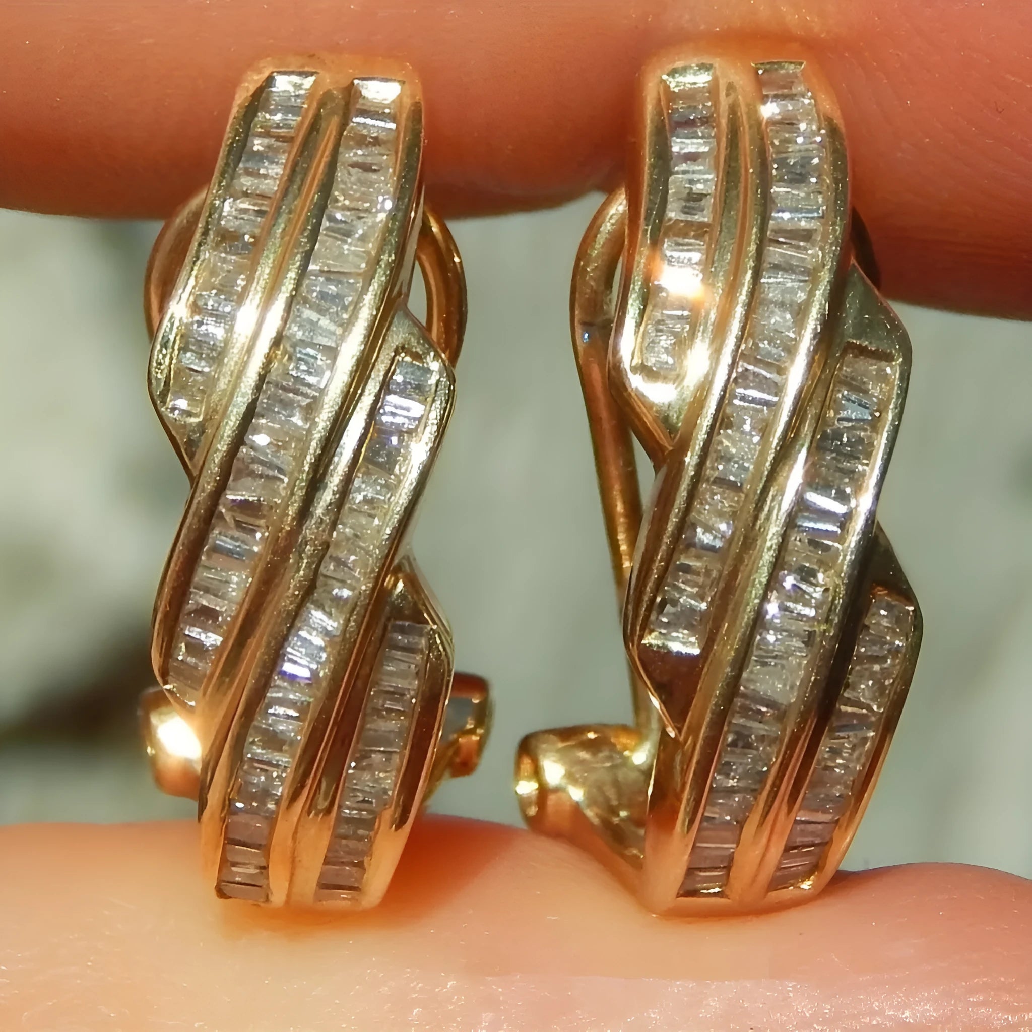 A pair of gold-coloured geometric earrings made from copper with a round design element.