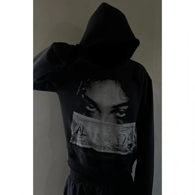 Women's black hoodie with a cartoon pattern print, loose fit.