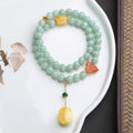 Close-up of a double-layer women's bracelet with green jade round beads and brown beeswax barrel beads in a geometric design.