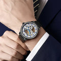 Men's luxury zircon mechanical watch with onion crown on a black leather strap, showing transparent case back.