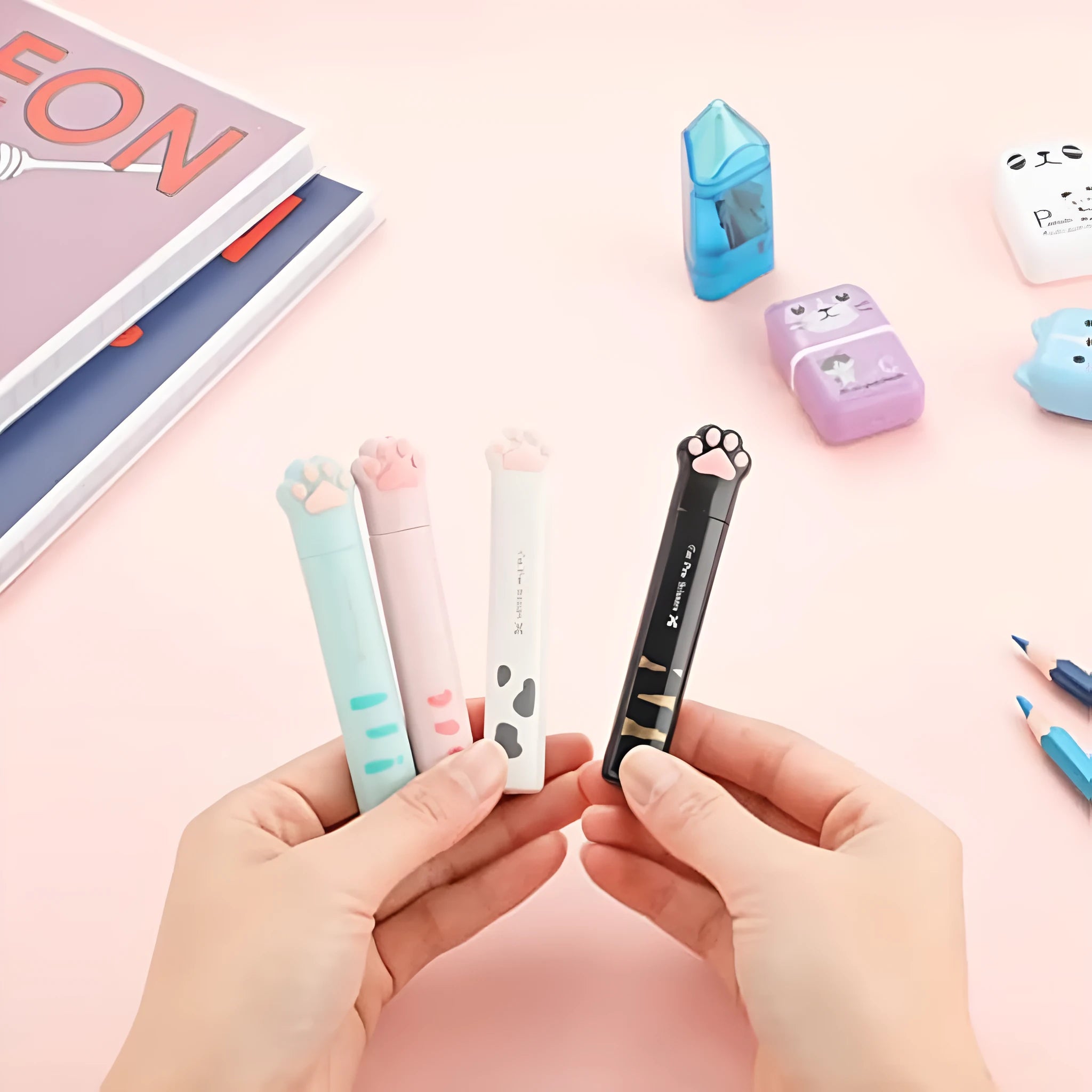 Cat paw design mini folding scissors in pink, showing stainless steel blades and compact size.
