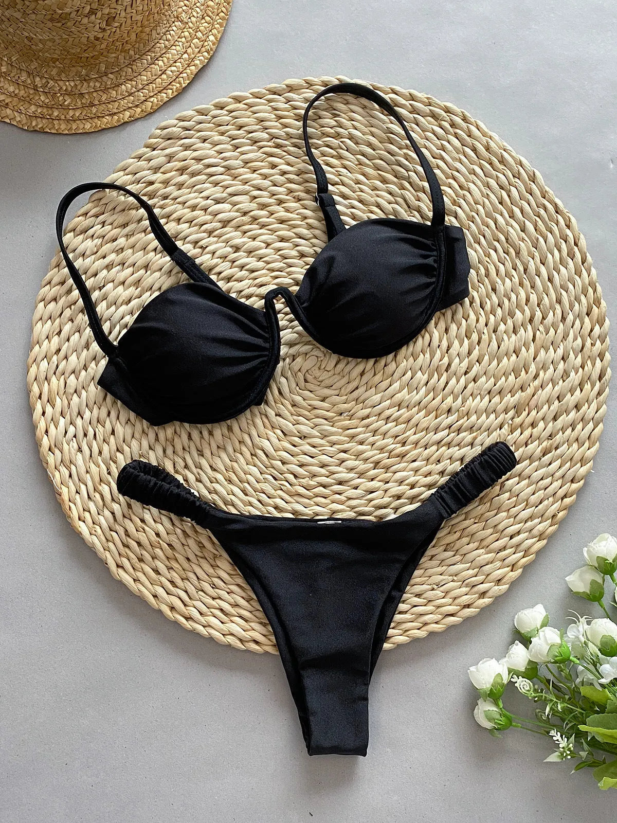 Women's black underwire bikini swimsuit with split briefs on a mannequin.