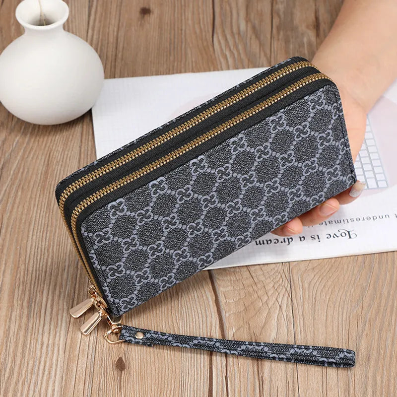 Long black PU leather wallet clutch with phone slot, card holders, and zippered coin purse