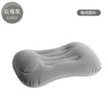Grey flocking inflatable travel pillow showing compact rectangular shape and textured surface.