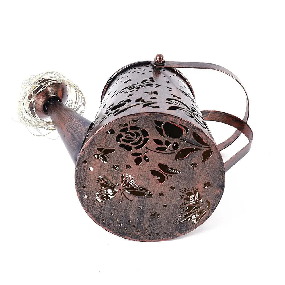 Solar-powered iron garden lamp with a tapered butterfly design in warm white.