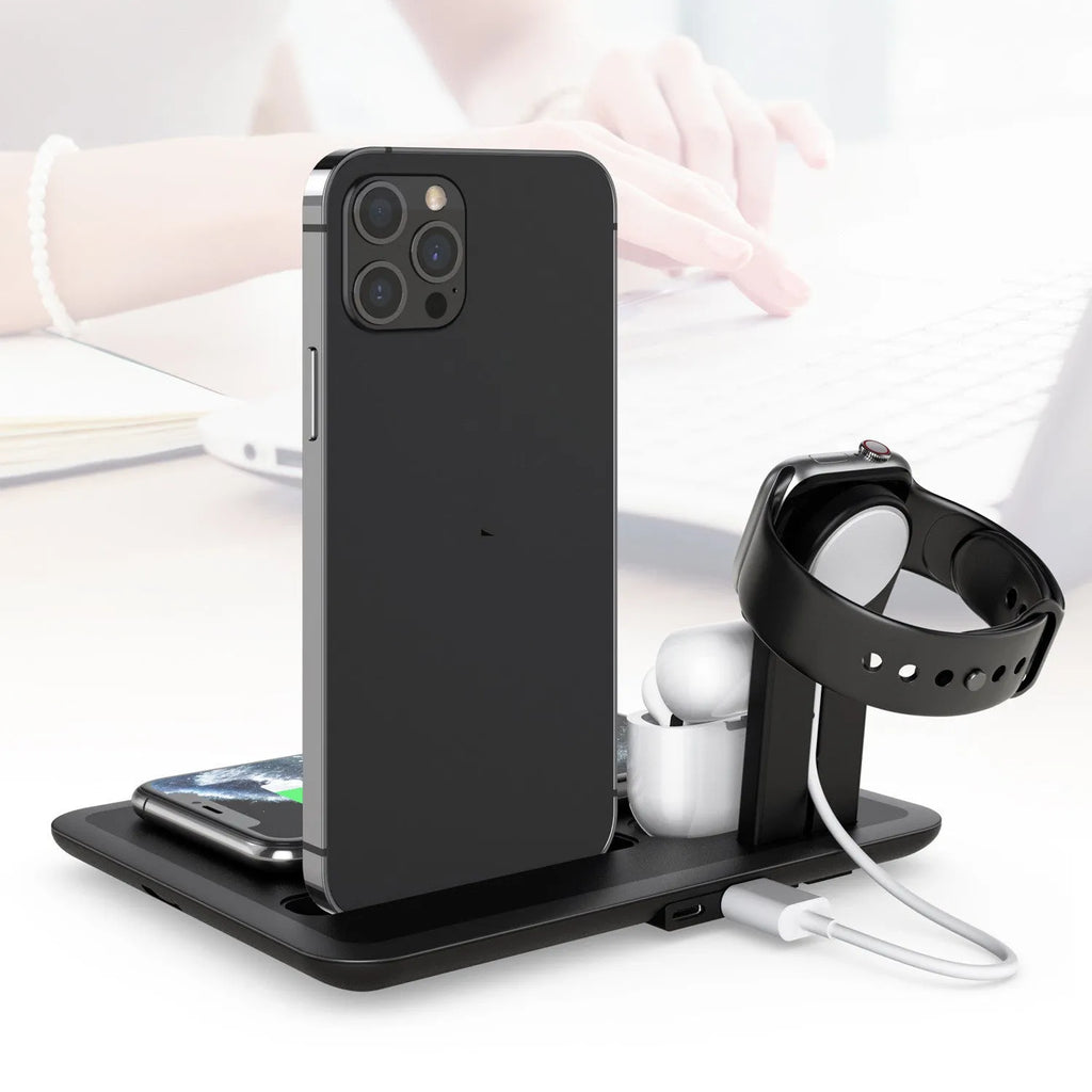 Black wireless charging station for phone watch headphones on desktop with USB cable