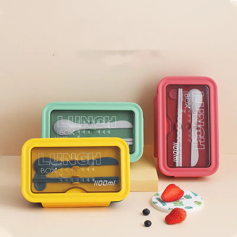 Green plastic bento lunch box with four food compartments showing Nordic design