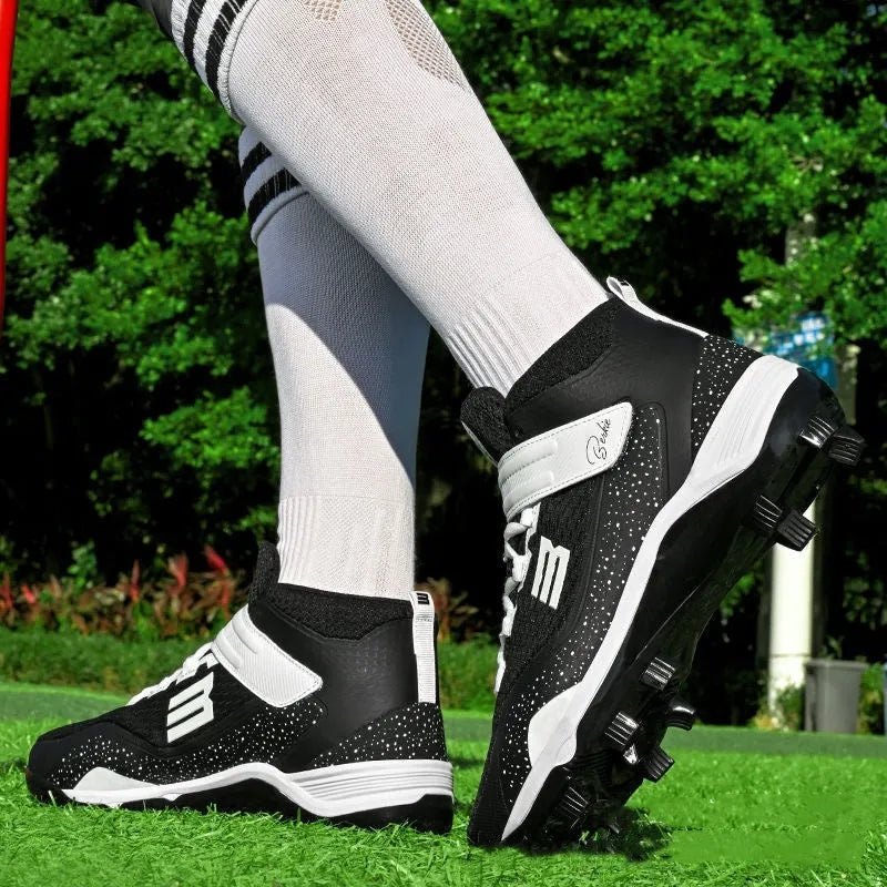 Black and white mid-top sports sneakers with velcro straps and a rubber sole.