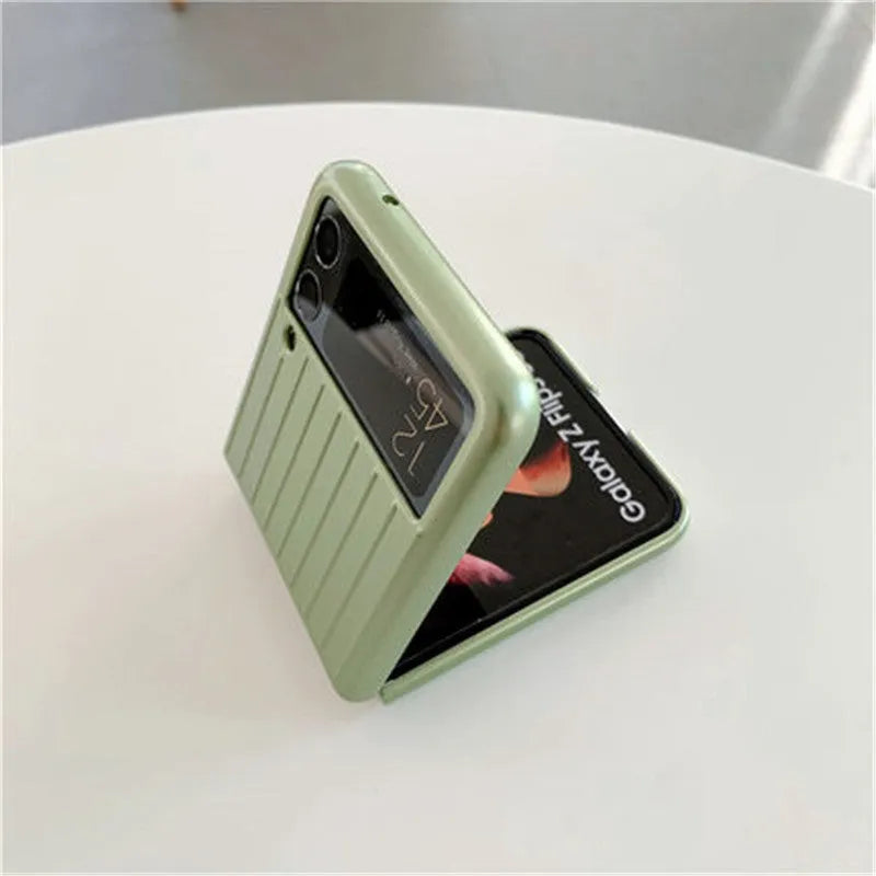 Ultra-thin black flip phone case for Samsung Z Flip3 folding mobile on a table.
