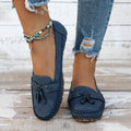 Women's suede casual flat shoes with a bow detail in pink, shown from the side.