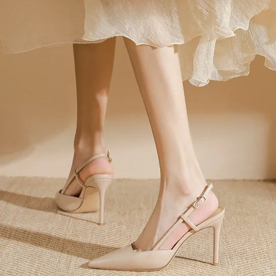 Apricot women's high-heeled sandals with a buckle toe strap and thin belts on a rubber sole.