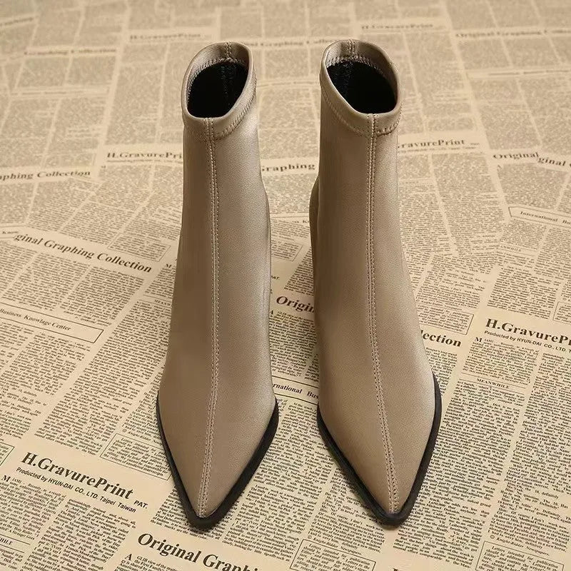 Women's khaki stretch suede pointed toe ankle boots with wedge heels on white background