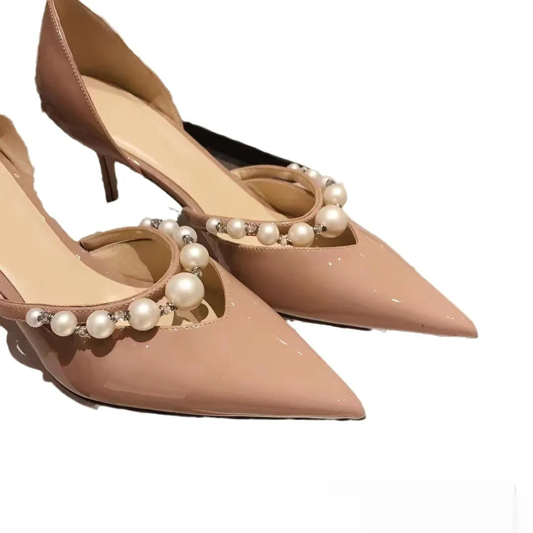 Women's patent leather pointed toe high heels with pearl accents on stiletto heel