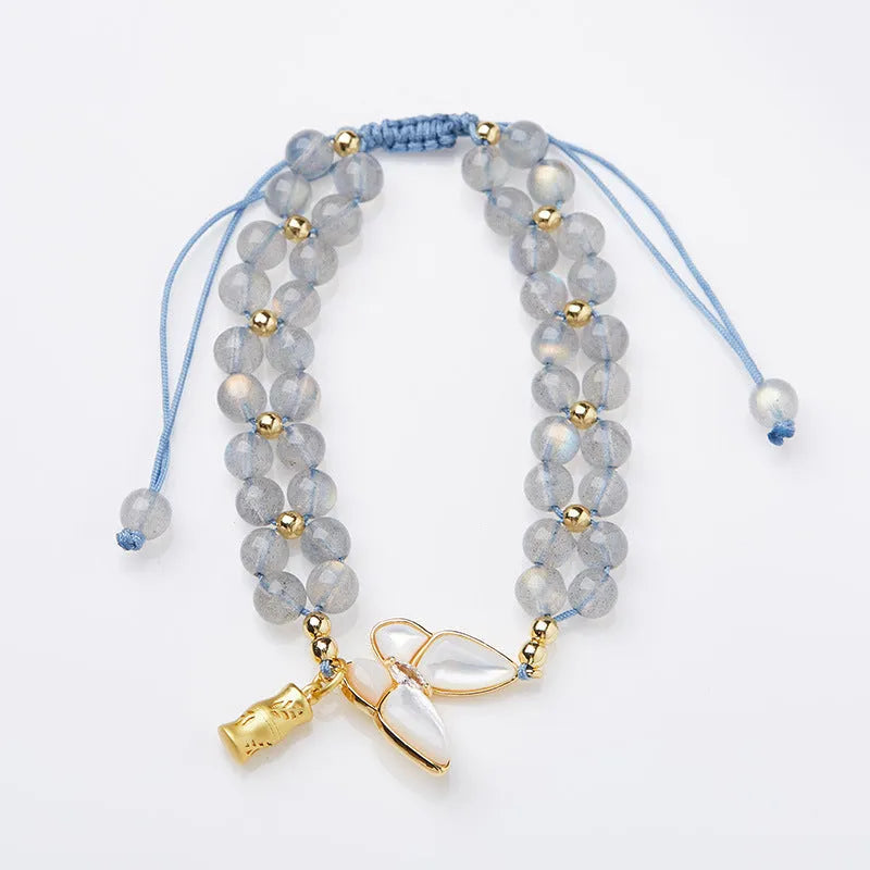 Handmade geometric woven bracelet for women with a grey moonstone and butterfly design.
