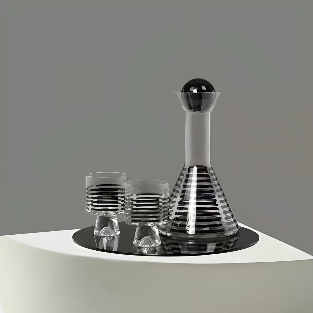 Modern black striped glass cold water bottle 1000ml with two cups on a light surface