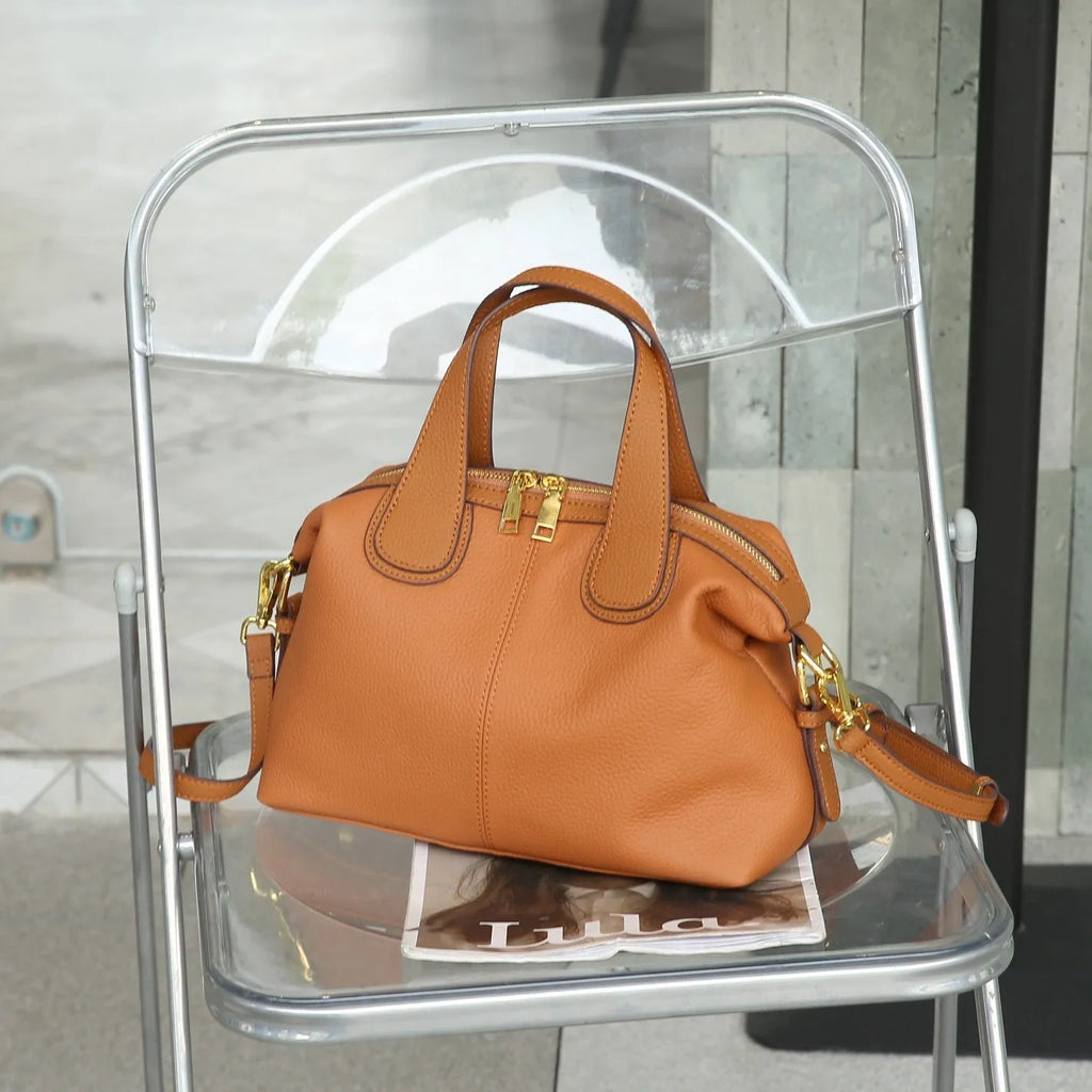 Women's leather cross-body shoulder bag in horizontal square shape with multiple internal zipped compartments