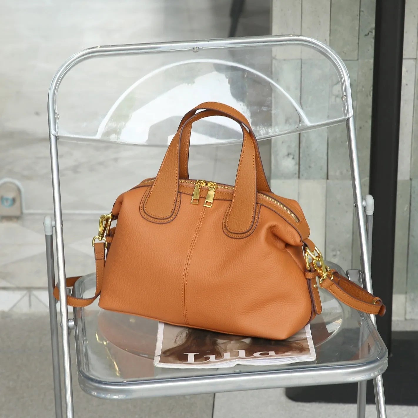 Women's leather cross-body shoulder bag in horizontal square shape with multiple internal zipped compartments