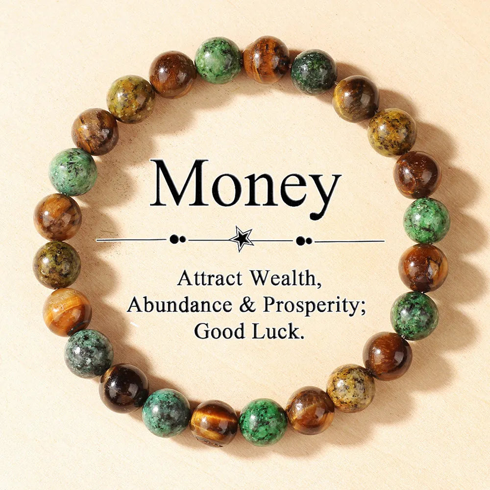 Handmade tigereye stone bracelet with 18mm flower bead in antique style on wrist.