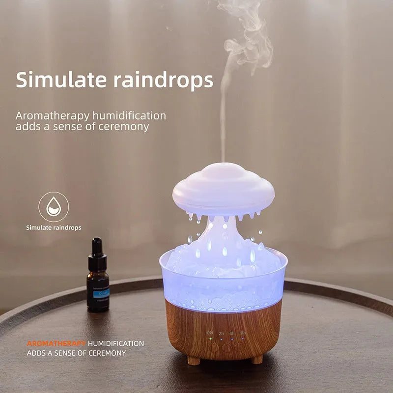 Wood grain white cloud-shaped humidifier and essential oil diffuser with coloured LED night light on a table.