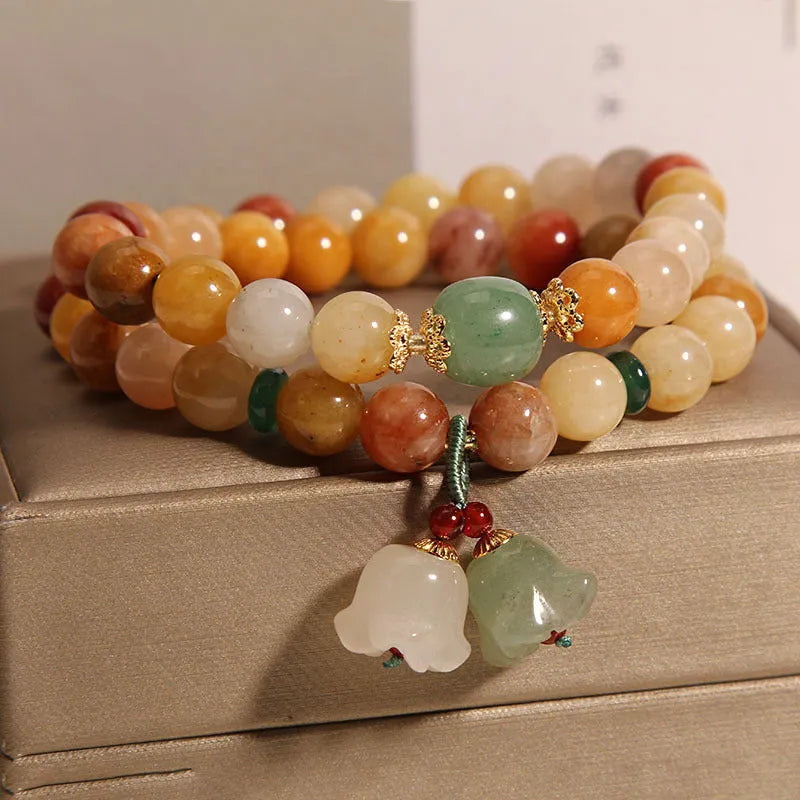 Natural jade multi-layer bracelet for women with an orchid pendant on an adjustable fastening.