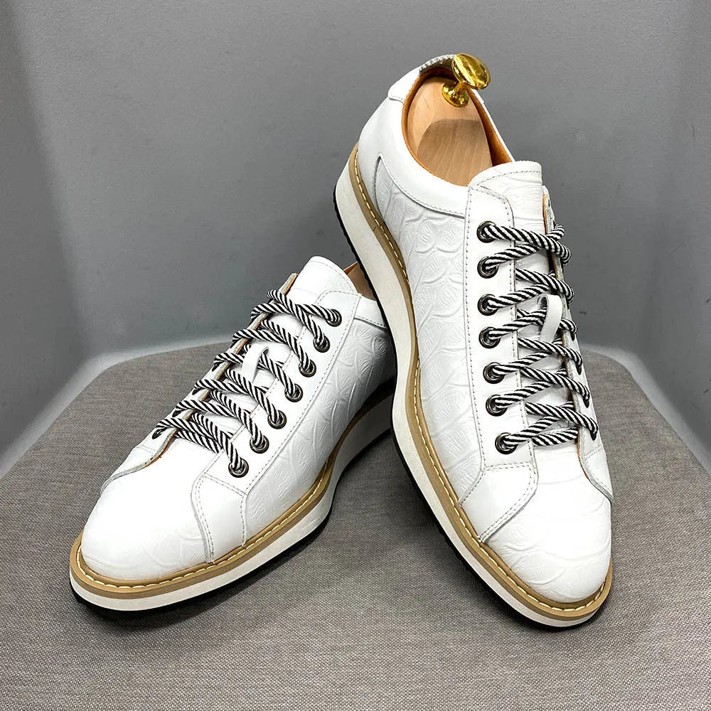 Men's low-top black embossed pattern handmade lace-up shoes on a white background.
