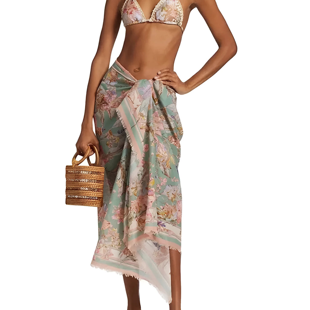 Women's beige floral bikini set with matching skirt on neutral background