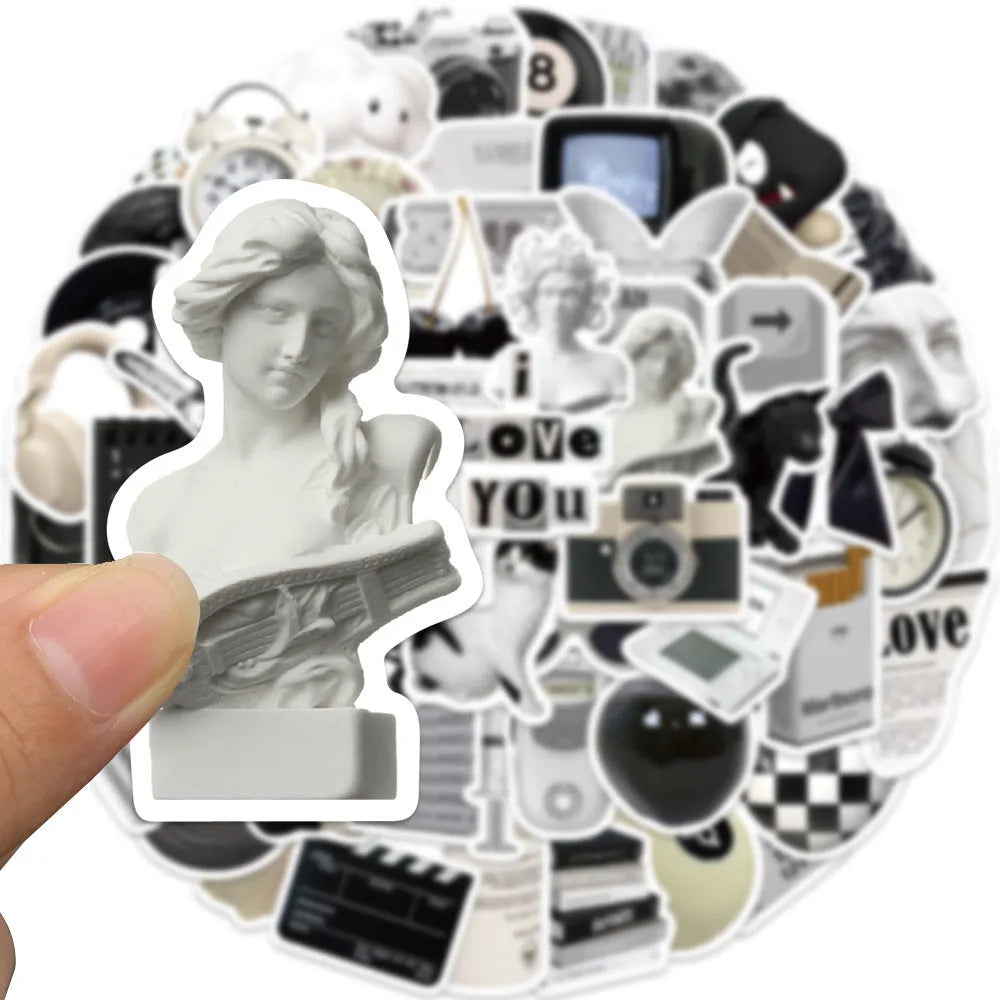 Assortment of black and white vinyl stickers featuring coffee cups and abstract designs for laptops and phones.