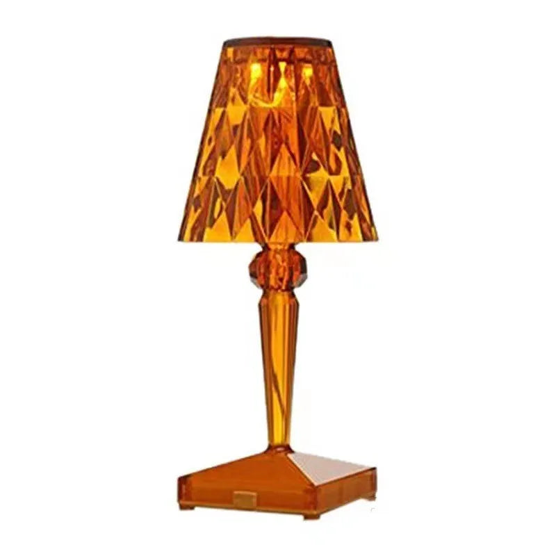 Rose gold portable touch-control projection night light on a wooden surface.