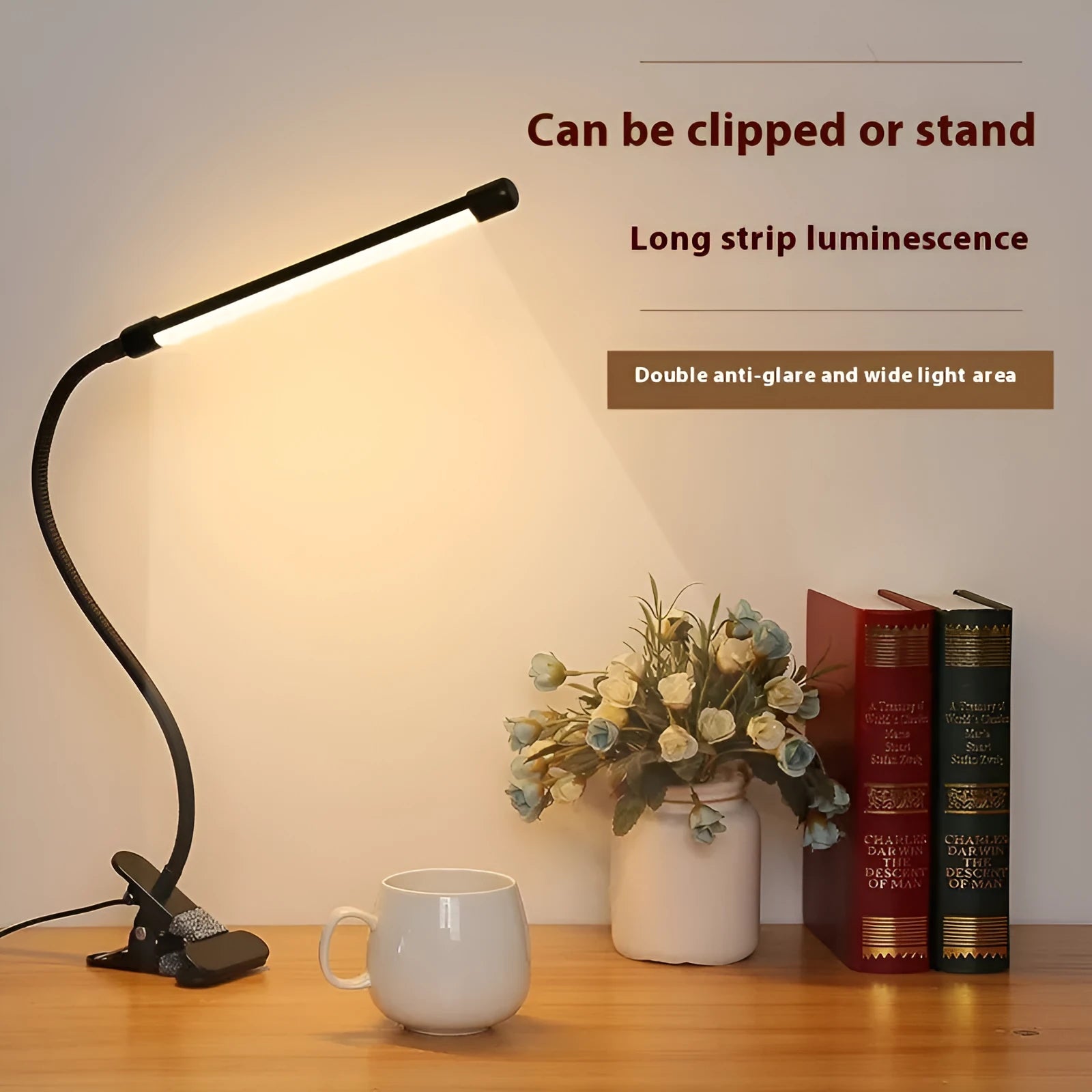 Black and white USB-powered LED desk lamp with a 26 cm long adjustable gooseneck neck on a table.