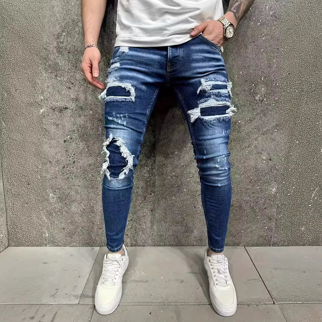 Men's denim jeans with worn-out patch detail in light blue, mid-waist tight fit British style