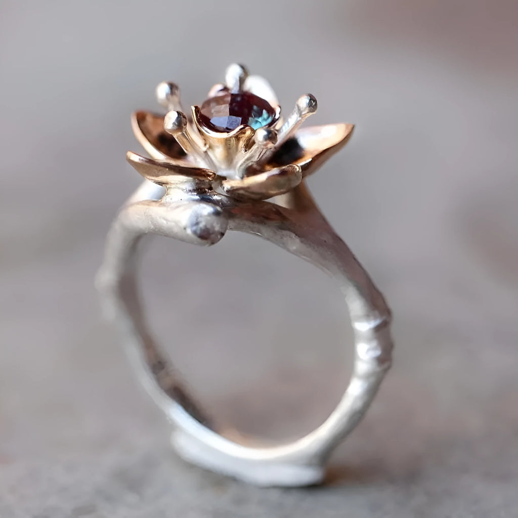 Silver two-tone floral geometric women's alloy ring on a plain background.