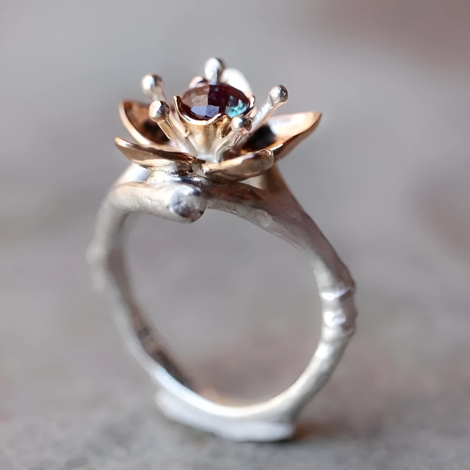 Silver two-tone floral geometric women's alloy ring on a plain background.