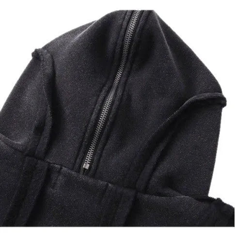Man wearing a loose black zip-up hooded coat with a padded lining.