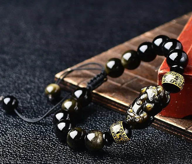 Hand-woven golden obsidian bracelet with Pi Xiu charm in 8mm, 10mm, 12mm, and 14mm bead sizes.