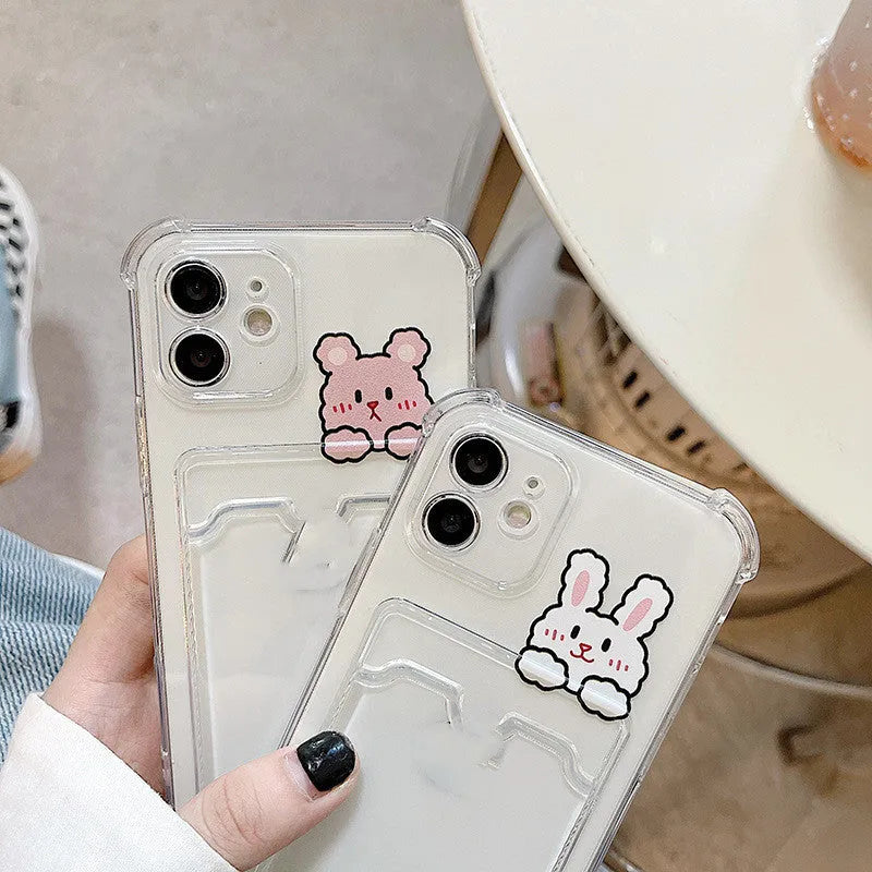 Clear cartoon-patterned iPhone case with a built-in card holder on the back.