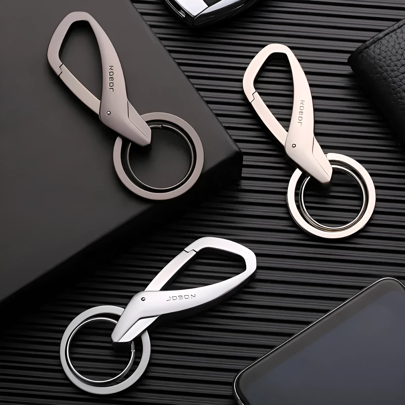 Black zinc alloy car key chain with two metal rings and a waist-hanging clip.