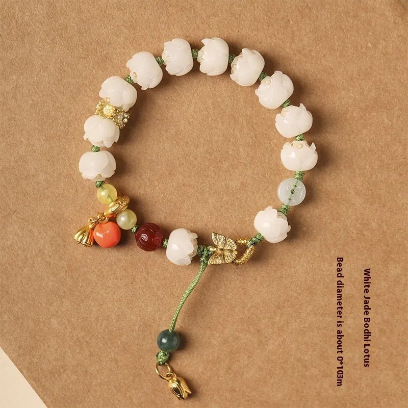 Close-up of a hand-woven white jade Bodhi bracelet with pumpkin and lotus beads on an adjustable rope.